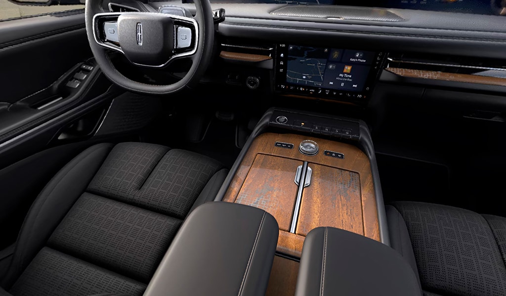 Khaya real-wood appliqué of the Invitation theme on the centre console of a 2026 Lincoln Black Label Navigator® SUV
