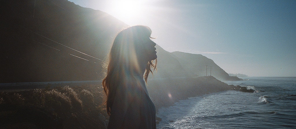 A woman enjoys a moment on a seaside overlook