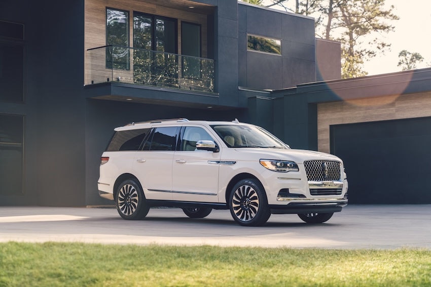 A 2024 Lincoln Navigator parked in front of a building.