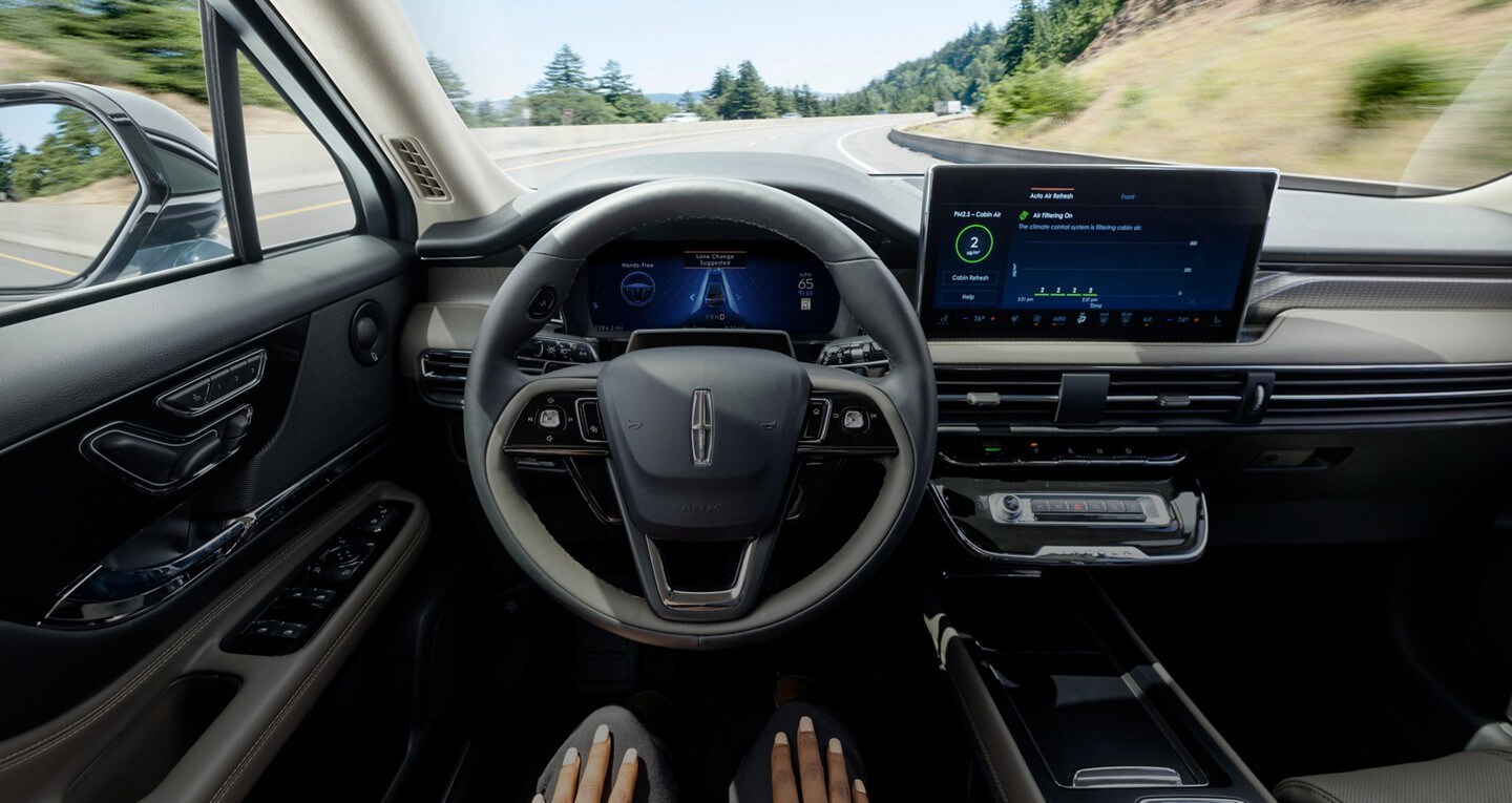 A driver of a 2023 Lincoln Black Label Navigator® SUV relaxes with hands-free driving technology engaged.