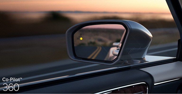 Looking at the warning alert on the driver side mirror which demonstrates Blind Spot Detection with Cross Traffic Alert and is part of Co Pilot 3 60