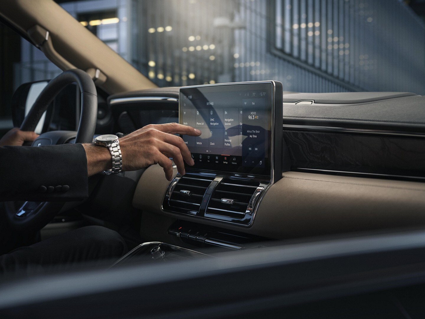 A man interacting with the touch screen inside the Lincoln Navigator