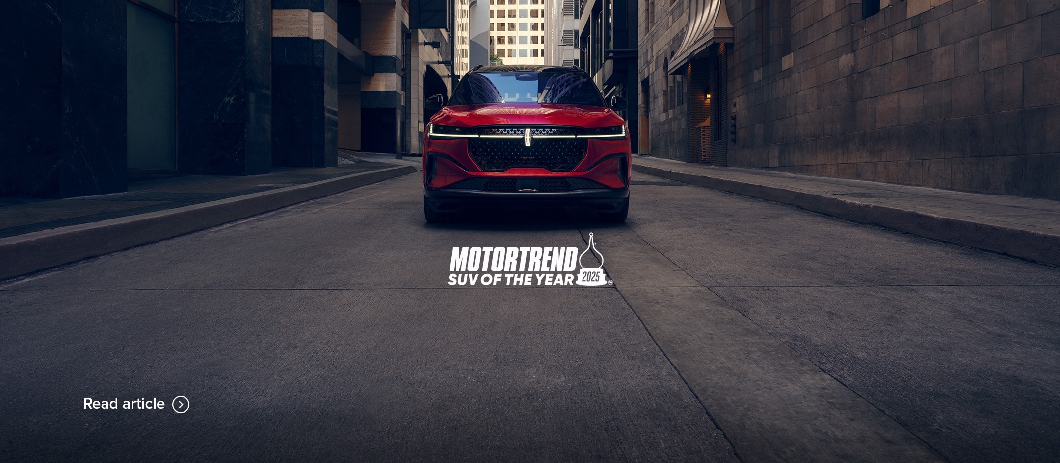 MotorTrend SUV of the Year 2025. Read the article. The 2025 Lincoln Nautilus parked on a road.