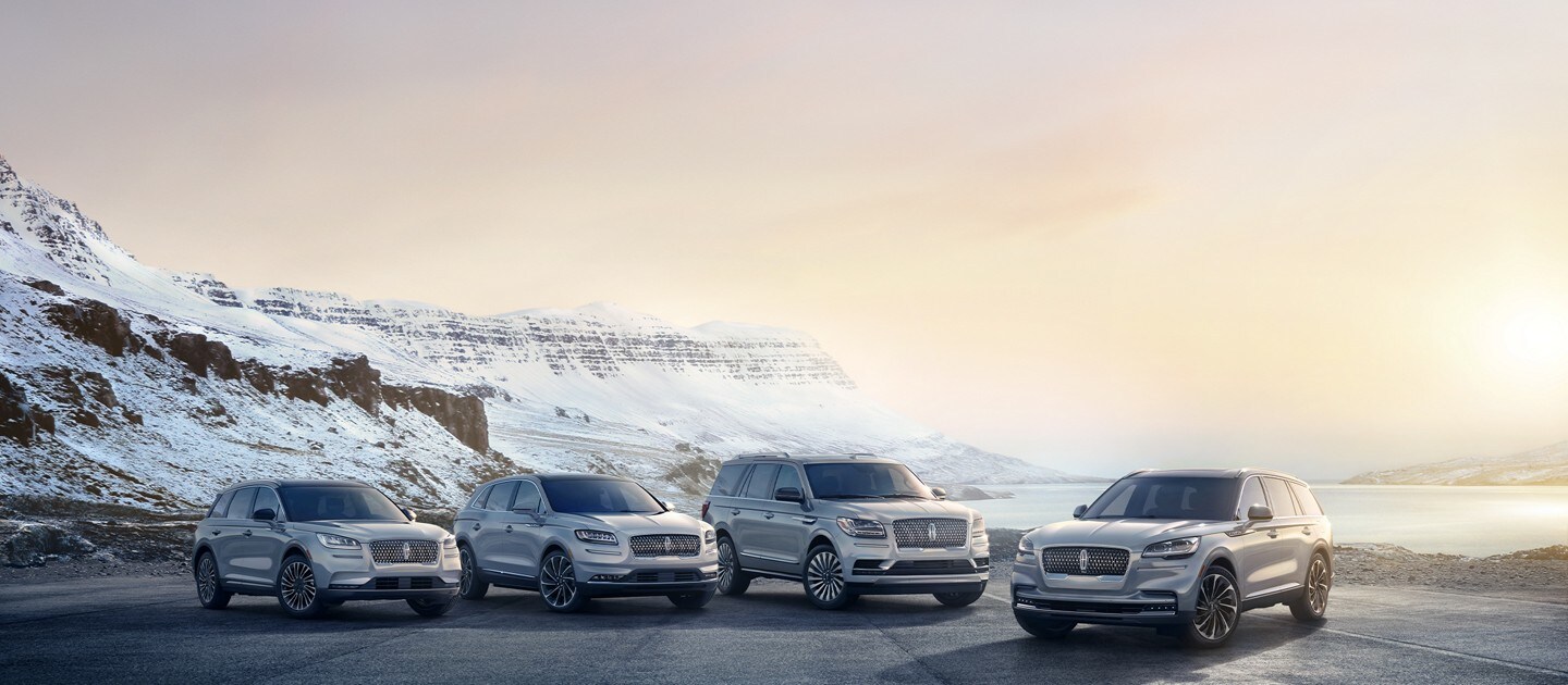A line up of Lincoln Canada vehicles in front of the mountains
