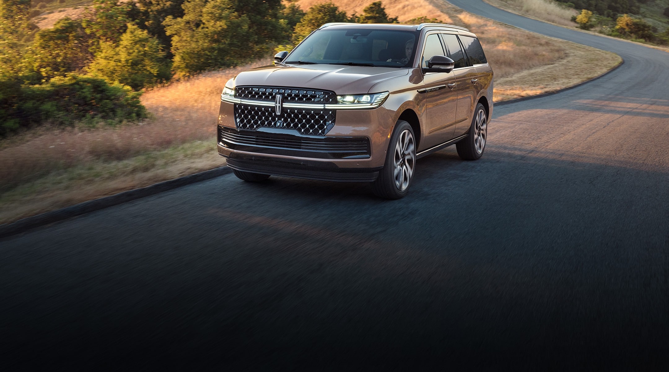 The 2025 Lincoln Black Label Navigator driving down the road.
