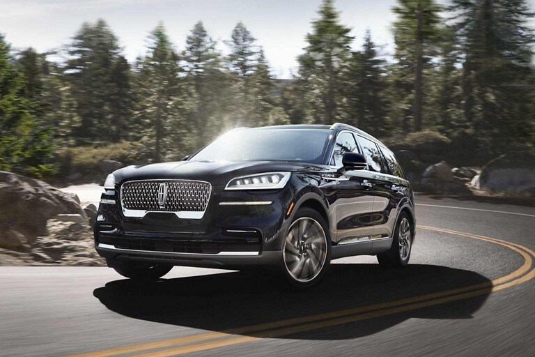 A 2023 Lincoln Aviator® being driven on a winding road