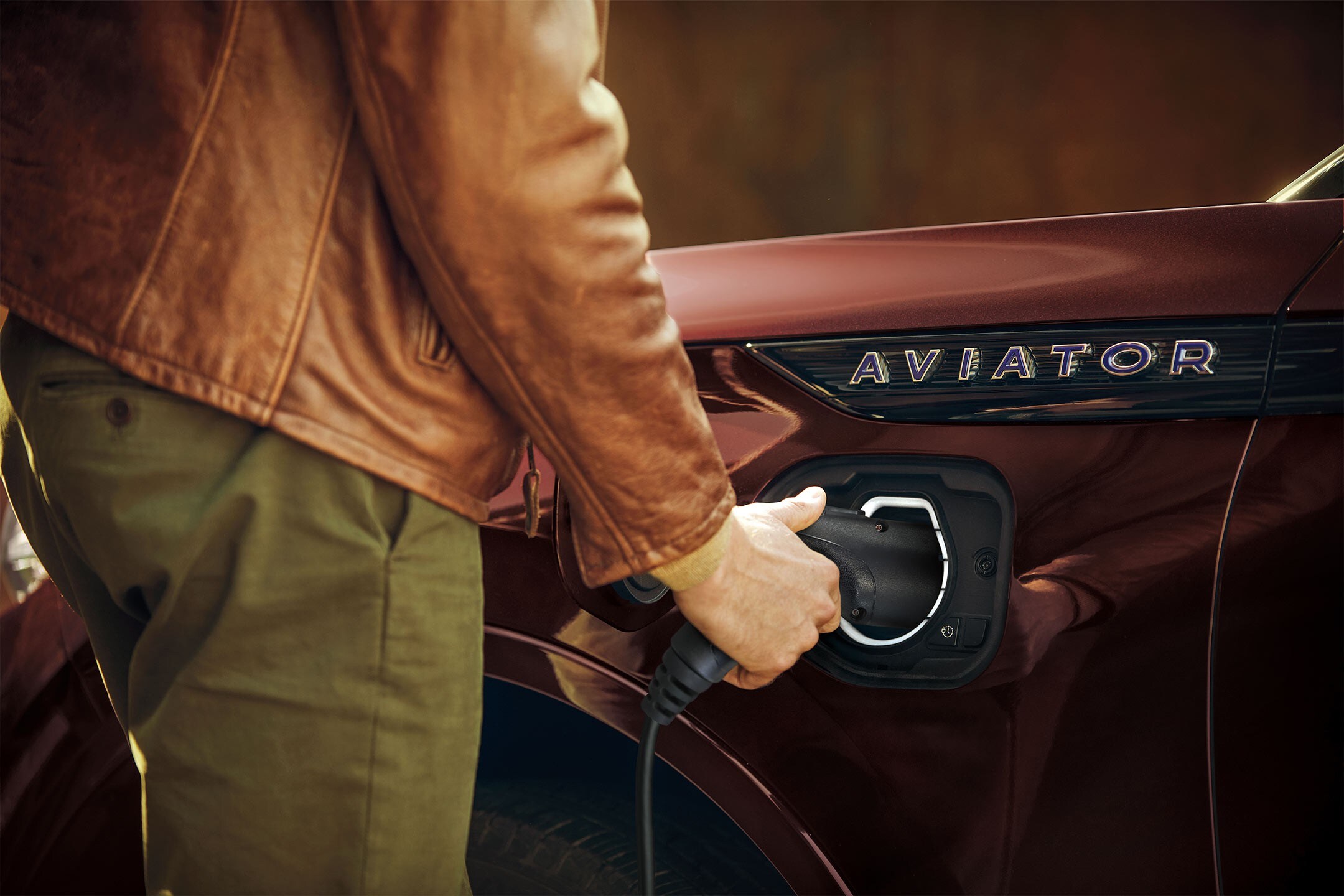 Person plugging in a Lincoln Mobile Power Cord into a 2023 Lincoln Aviator® Grand Touring model