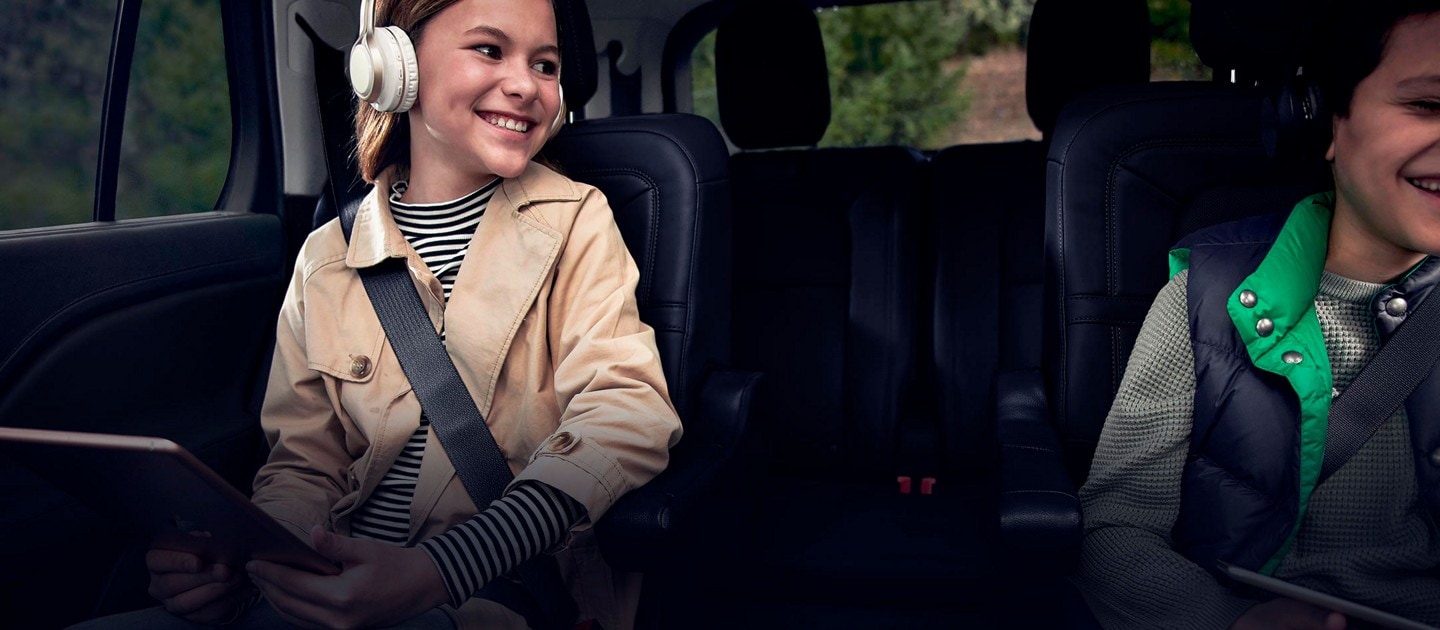 Two children are comfortably seated in the second row of a 2024 Lincoln Aviator