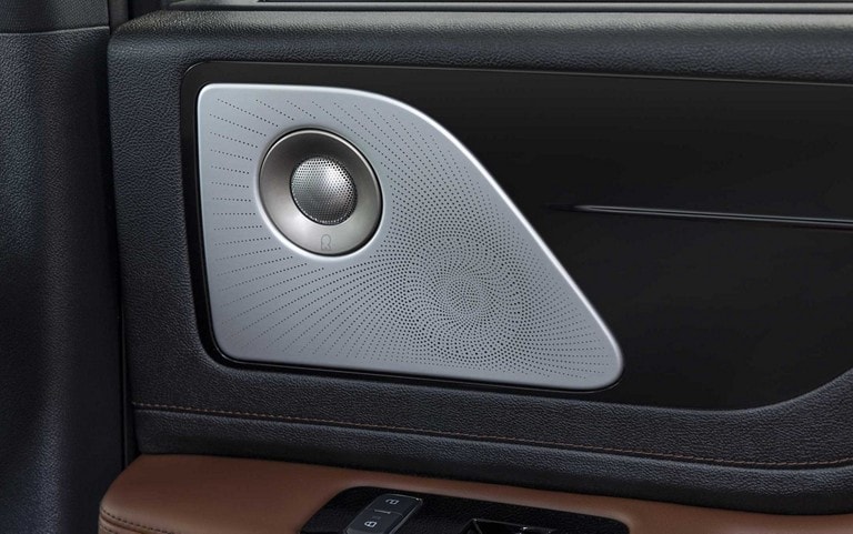 A Revel speaker is shown on the interior door pane of a 2025 Lincoln Aviator