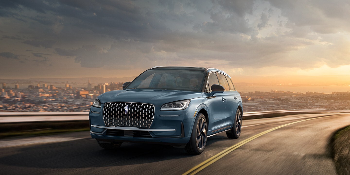 A 2023 Lincoln Corsair Grand Touring SUV is being driven on a hillside road