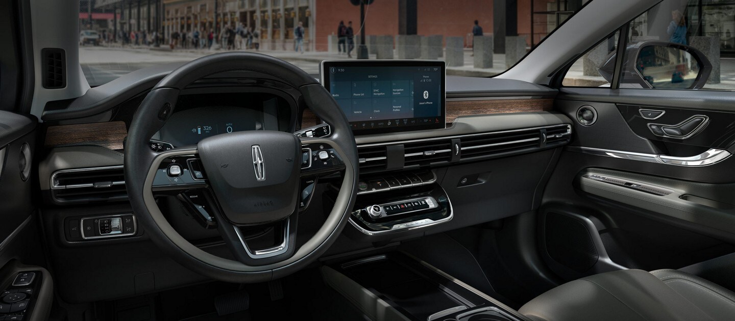 The interior of a Lincoln Corsair that is parked on a city street