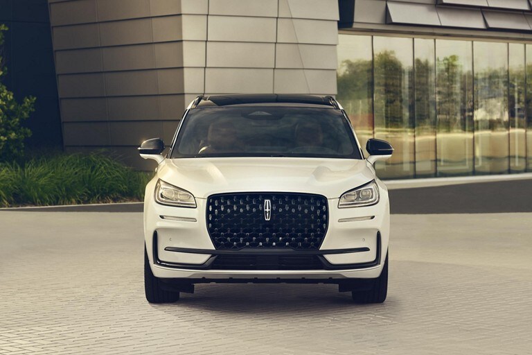 The dazzling LED headlamps of a 2024 Lincoln Corsair sparkle in the sunlight