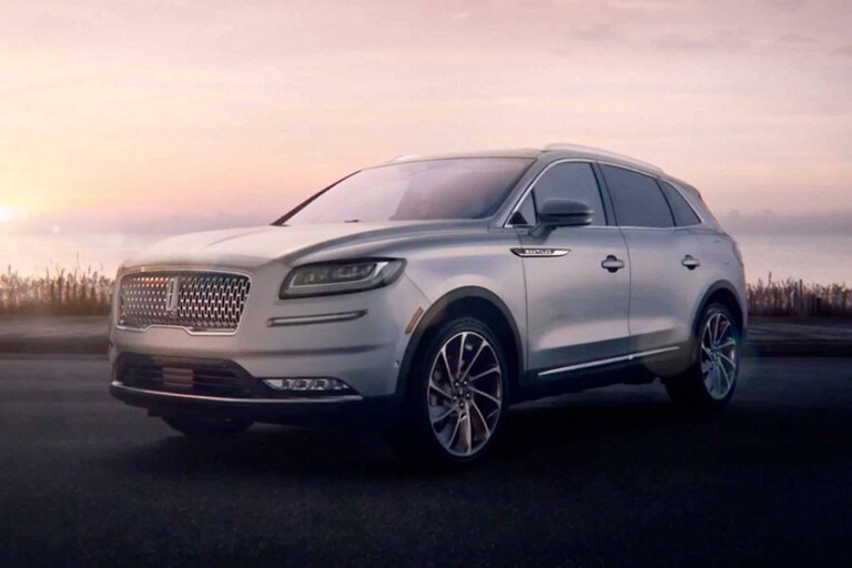 A 2023 Lincoln Nautilus SUV is parked by the ocean at dawn