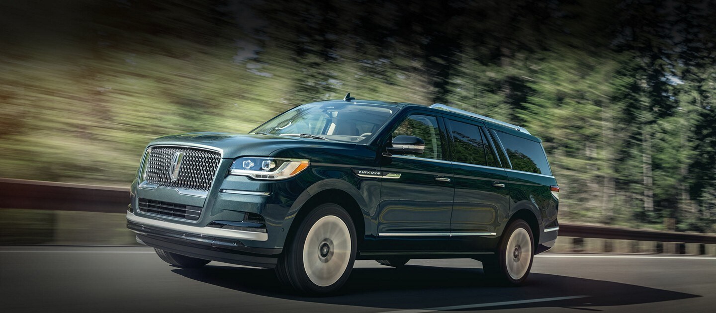A low front-end shot of a 2023 Lincoln Reserve Navigator SUV emphasizes the chrome Lincoln grille design