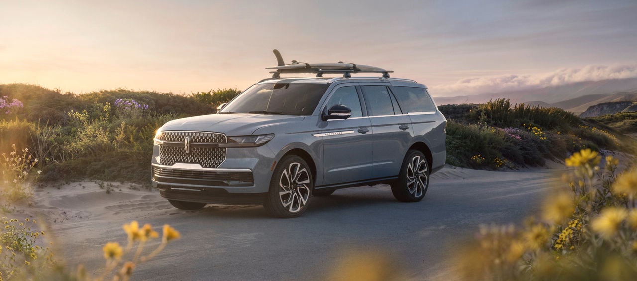 Lincoln Navigator SUV parked on a scenic coastal road.
