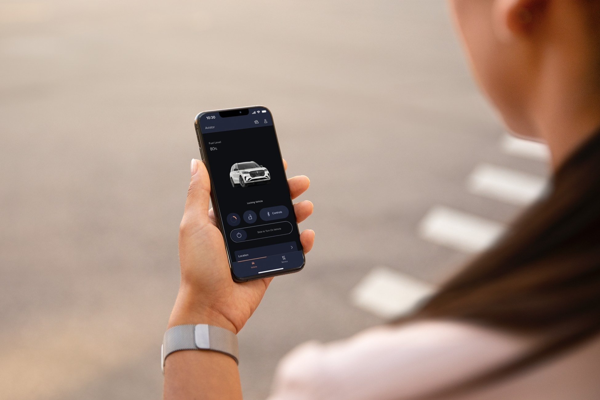 Someone is shown holding a mobile device displaying the Lincoln Way app.