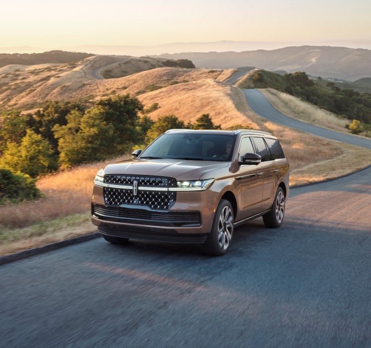 The Lincoln Black Label Navigator driving down a road.