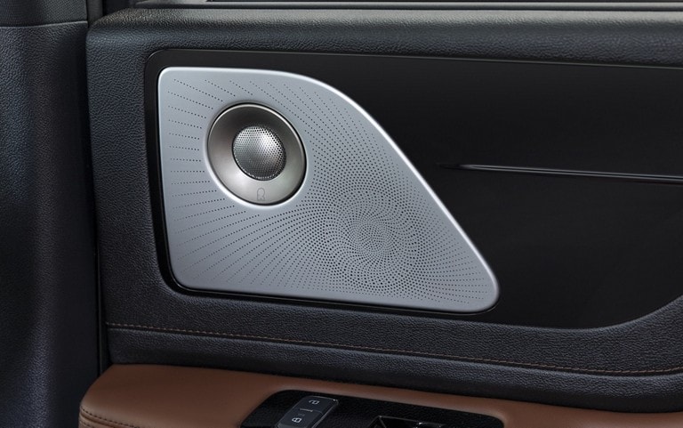 A Revel speaker is shown on the interior door pane of a 2025 Lincoln Aviator