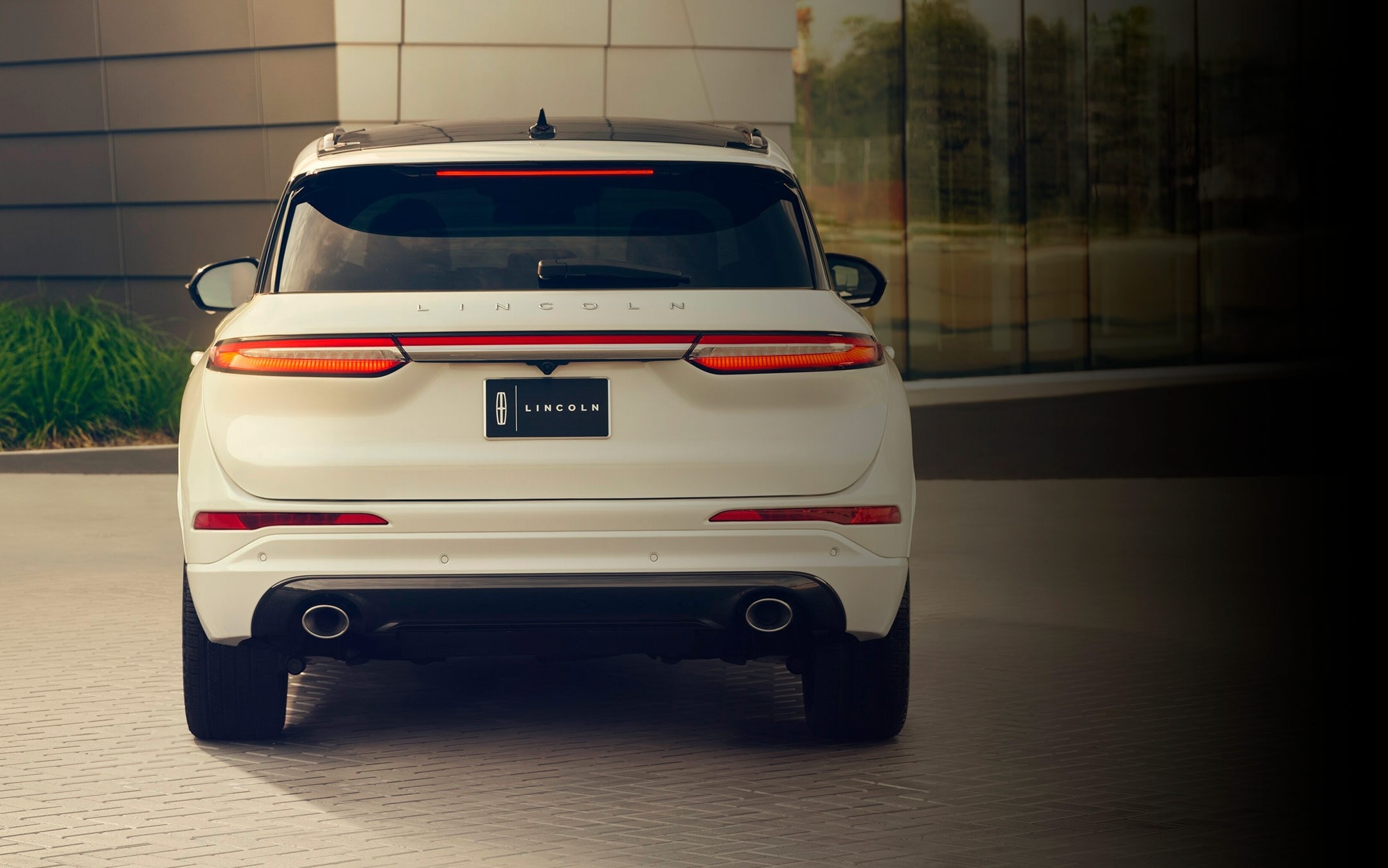 The rear of a 2025 Lincoln Corsair is shown with LED brake lights illuminated