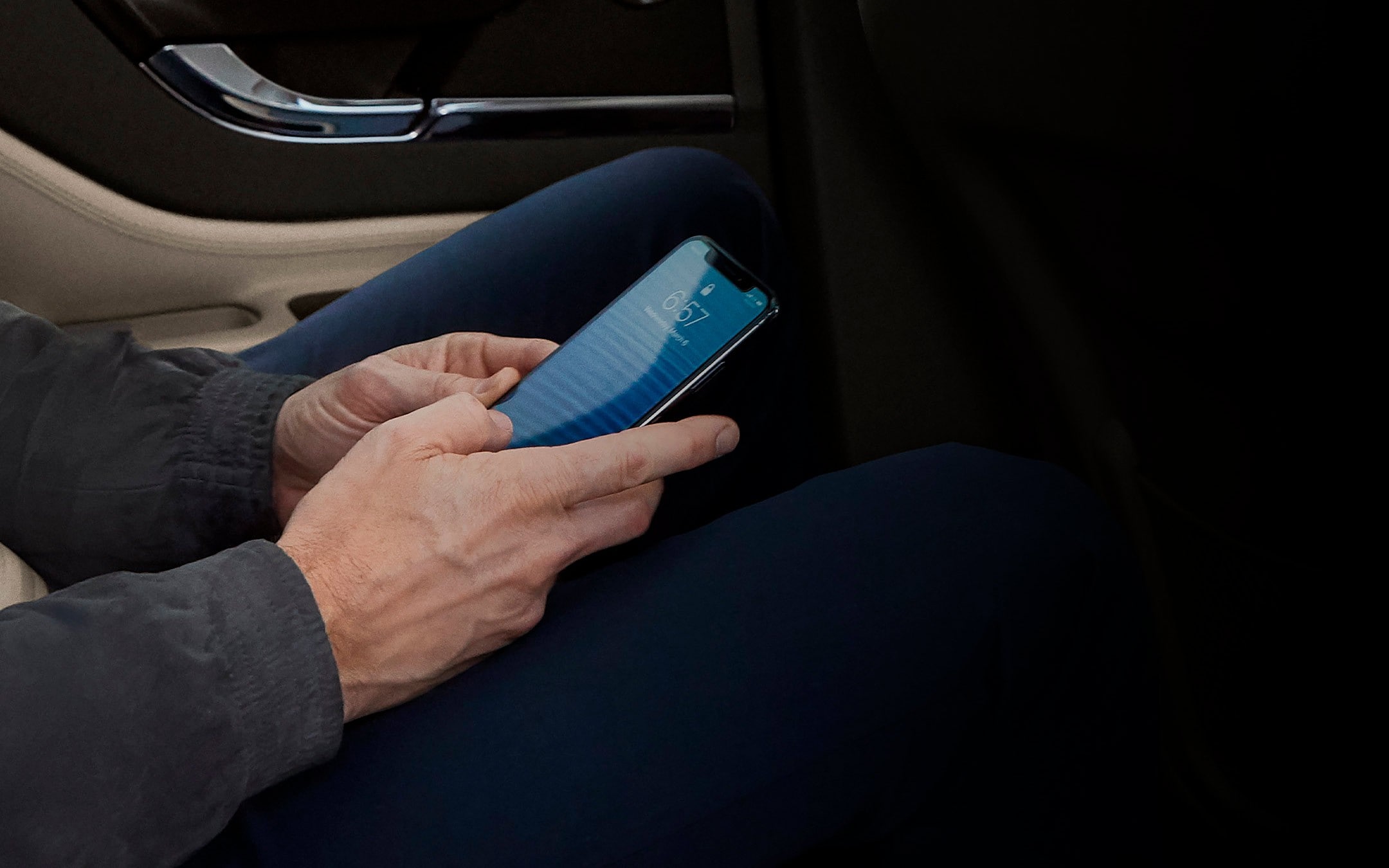 A person is shown using a mobile phone while using a 2026 Lincoln Corsair as a mobile Wi-Fi hotspot