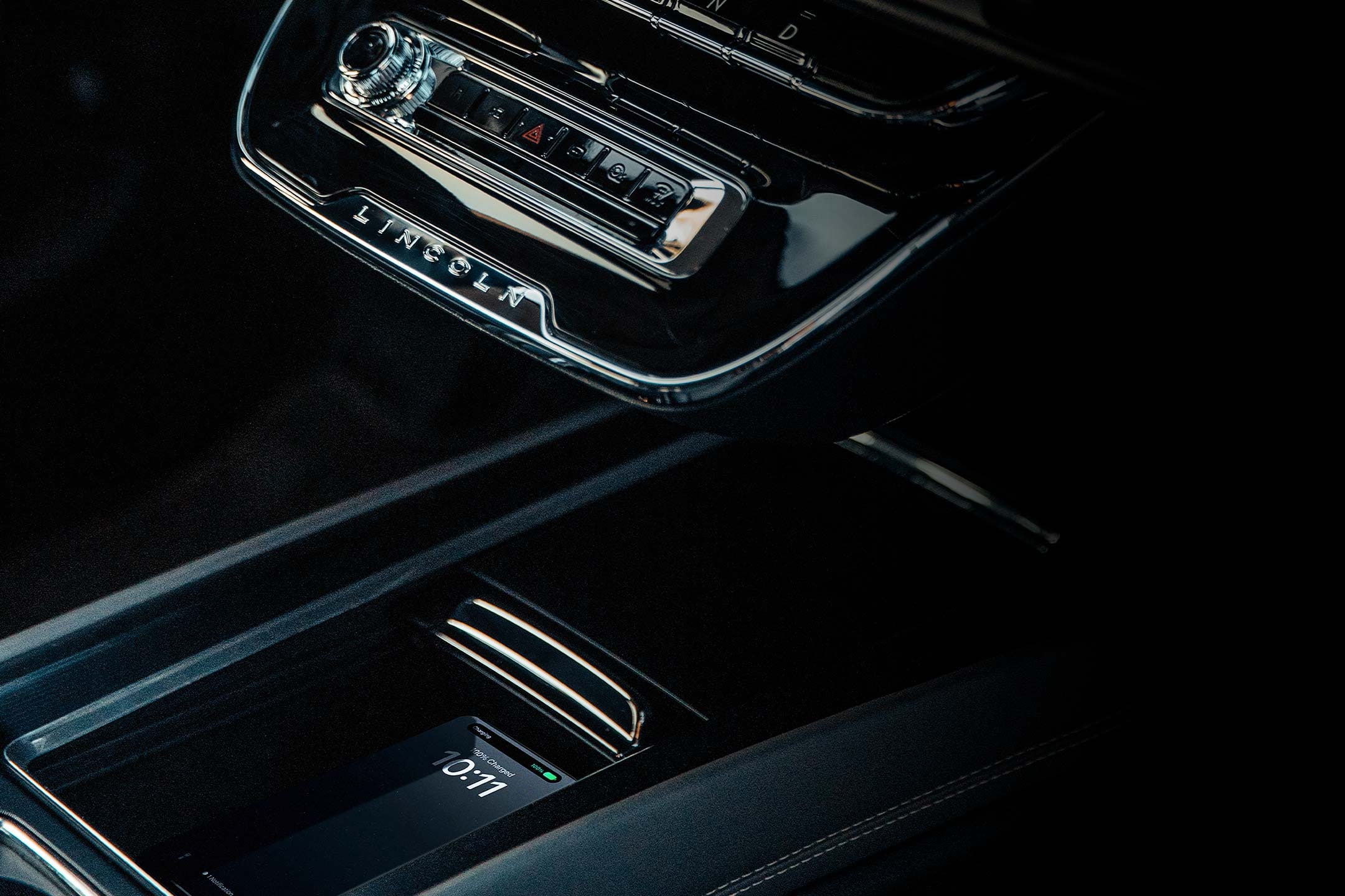 A mobile phone is on the available wireless charger inside a 2026 Lincoln Corsair SUV