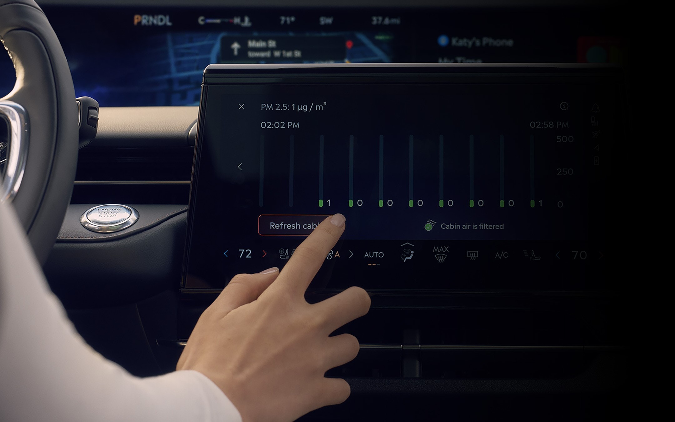 A person interacts with the centre touch screen to adjust available Auto Air Refresh