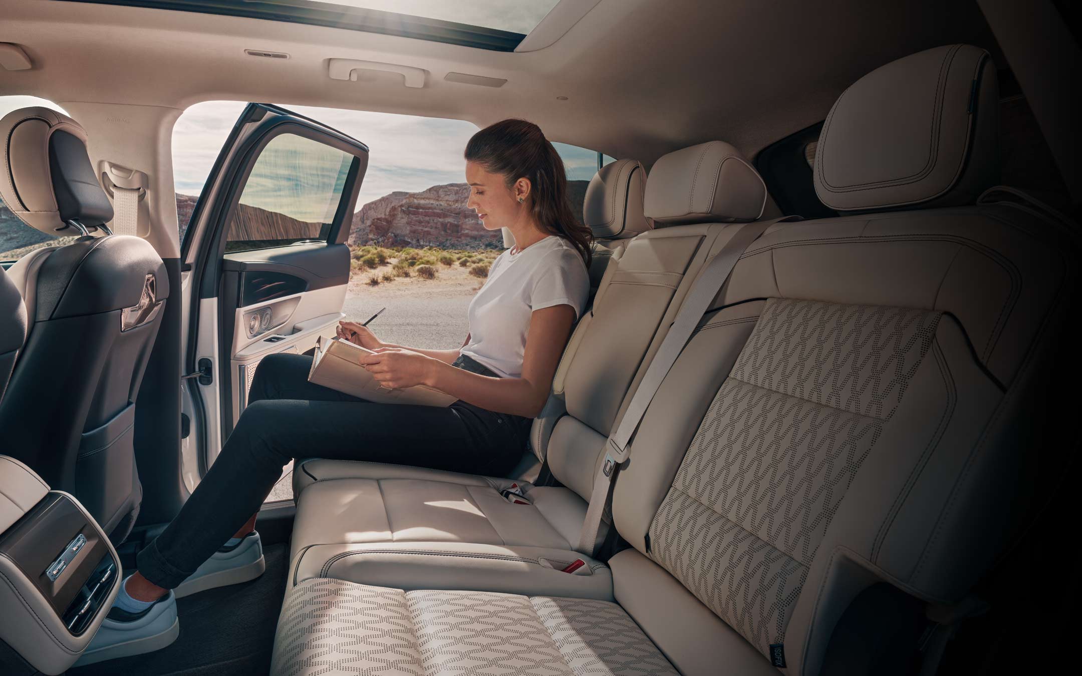 A woman sits in the second row of a 2026 Lincoln Nautilus