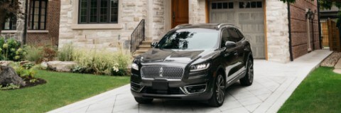 2019 Lincoln Nautilus in Infinite Black parked in driveway at large house