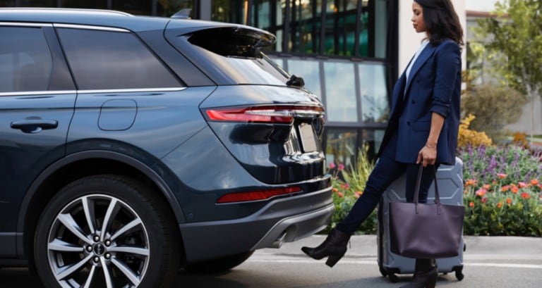 Woman using hands free foot activated liftgate on rear of 2020 Lincoln Corsair