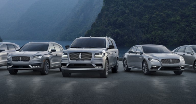 Various blue 2018 and 2019 Lincoln vehicles parked in front of mountains