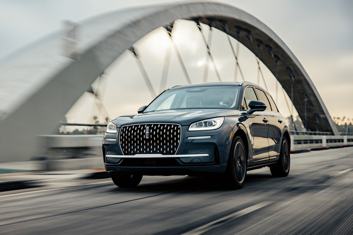 A Lincoln SUV is shown driving over a bridge.