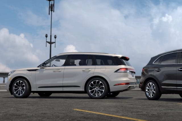 a Lincoln® vehicle and another vehicle reversing toward each other is shown here