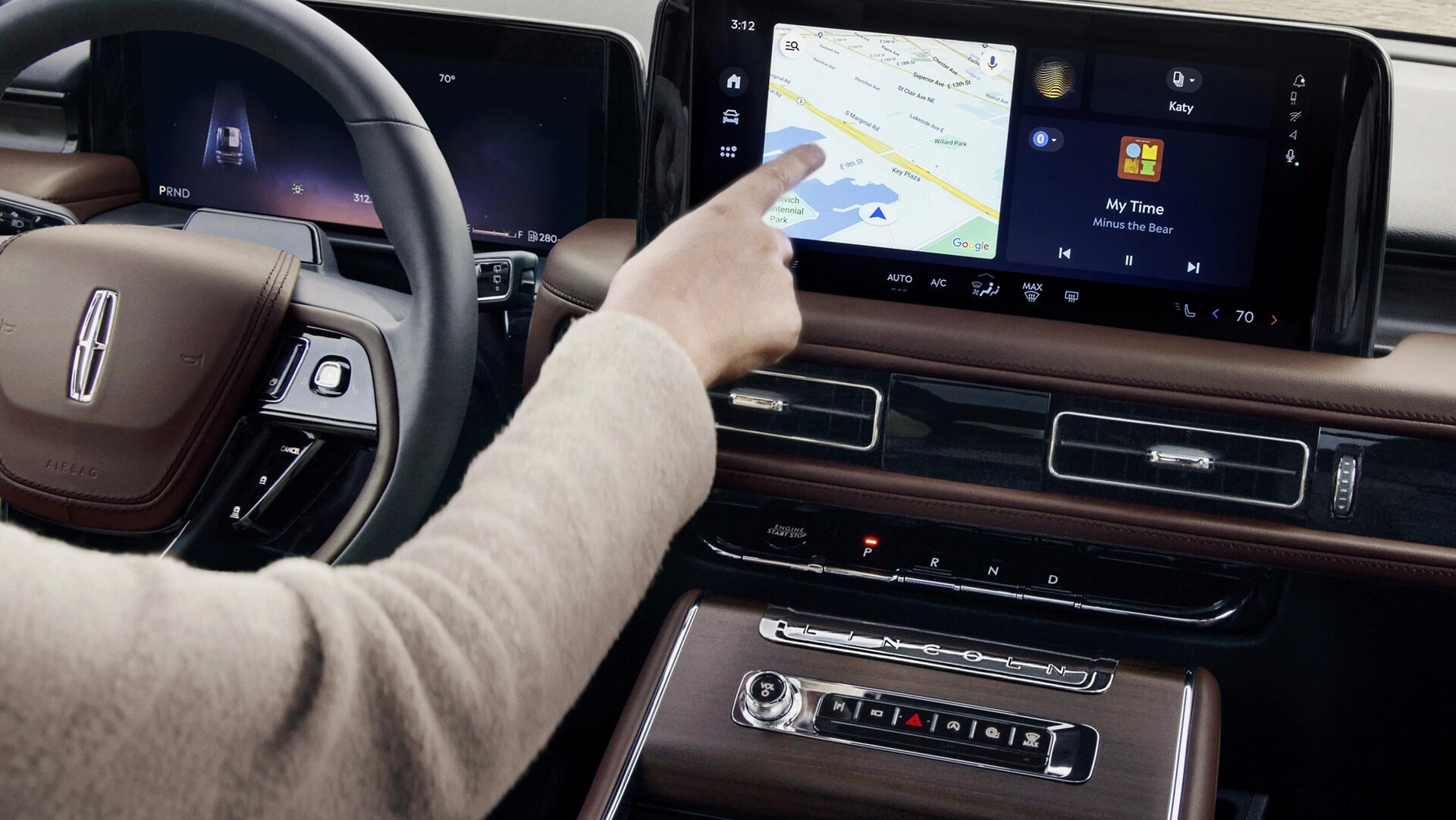 The driver of a 2026 Lincoln Aviator touches the centre touchscreen