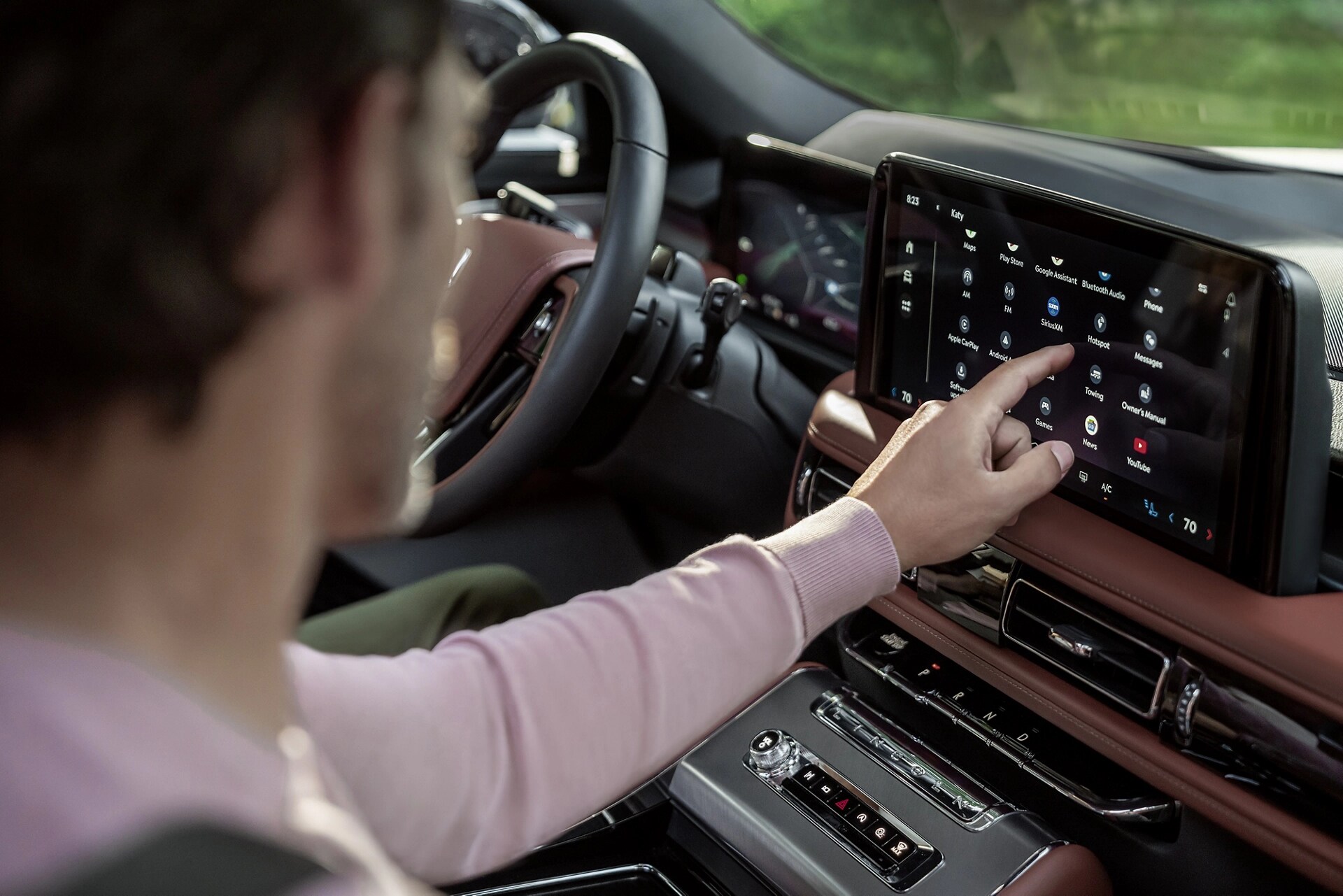 The front passenger touches the centre touch screen inside a 2026 Lincoln Aviator