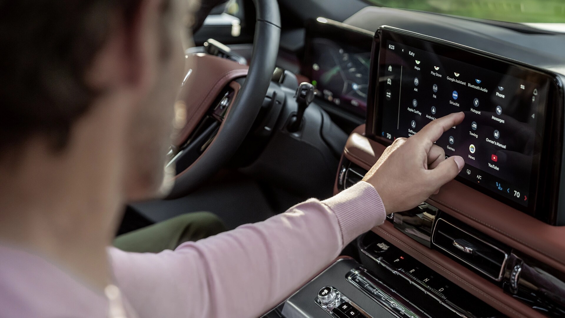 The front passenger touches the centre touch screen inside a 2026 Lincoln Aviator