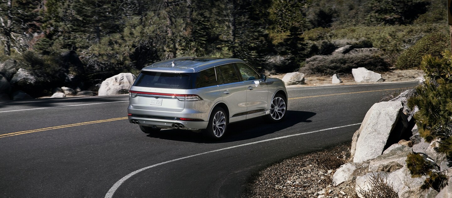 2023 Lincoln Aviator® with available Intelligent Adaptive Cruise Control with Speed Sign Recognition on a curved highway