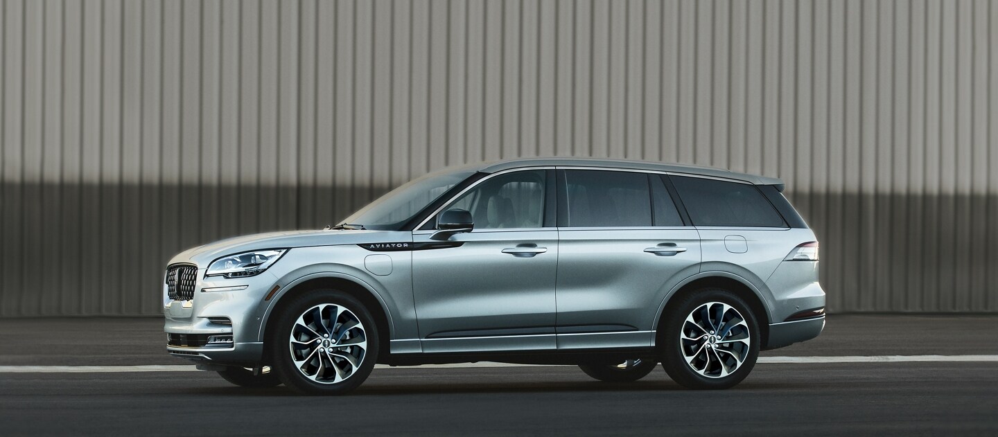 2023 Lincoln Aviator® Grand Touring model parked next to an airplane hangar