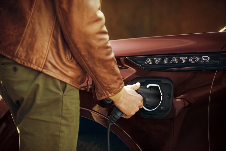Driver uses the at-home charging station to help power the 2023 Lincoln Aviator® Grand Touring model