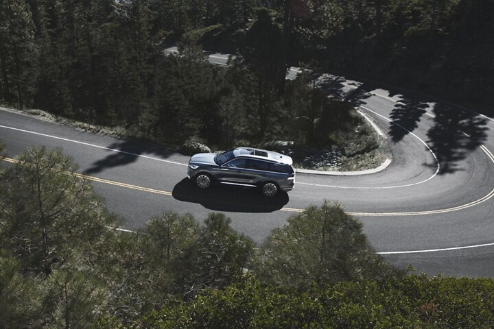 2023 Lincoln Aviator® is seen from above as it travels along a winding mountain road