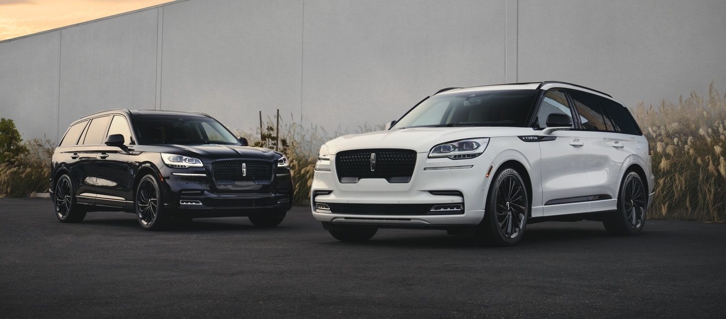 Two parked 2024 Lincoln Aviators with the Jet Appearance Package in a parking lot