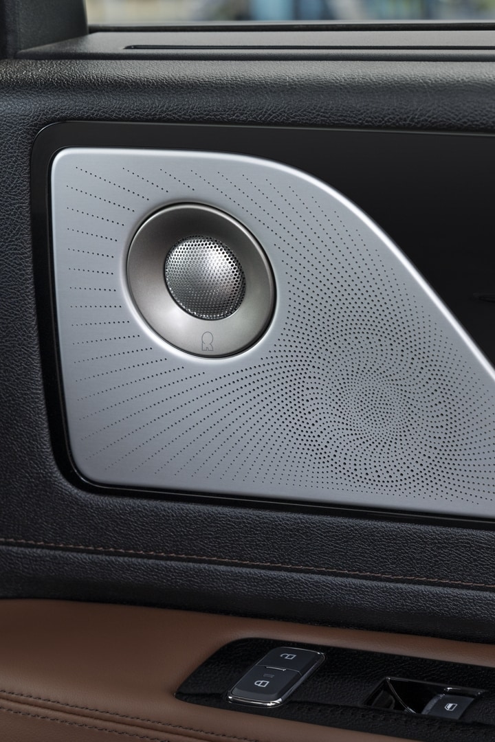 A Revel speaker is shown on the interior door pane of a 2025 Lincoln Aviator