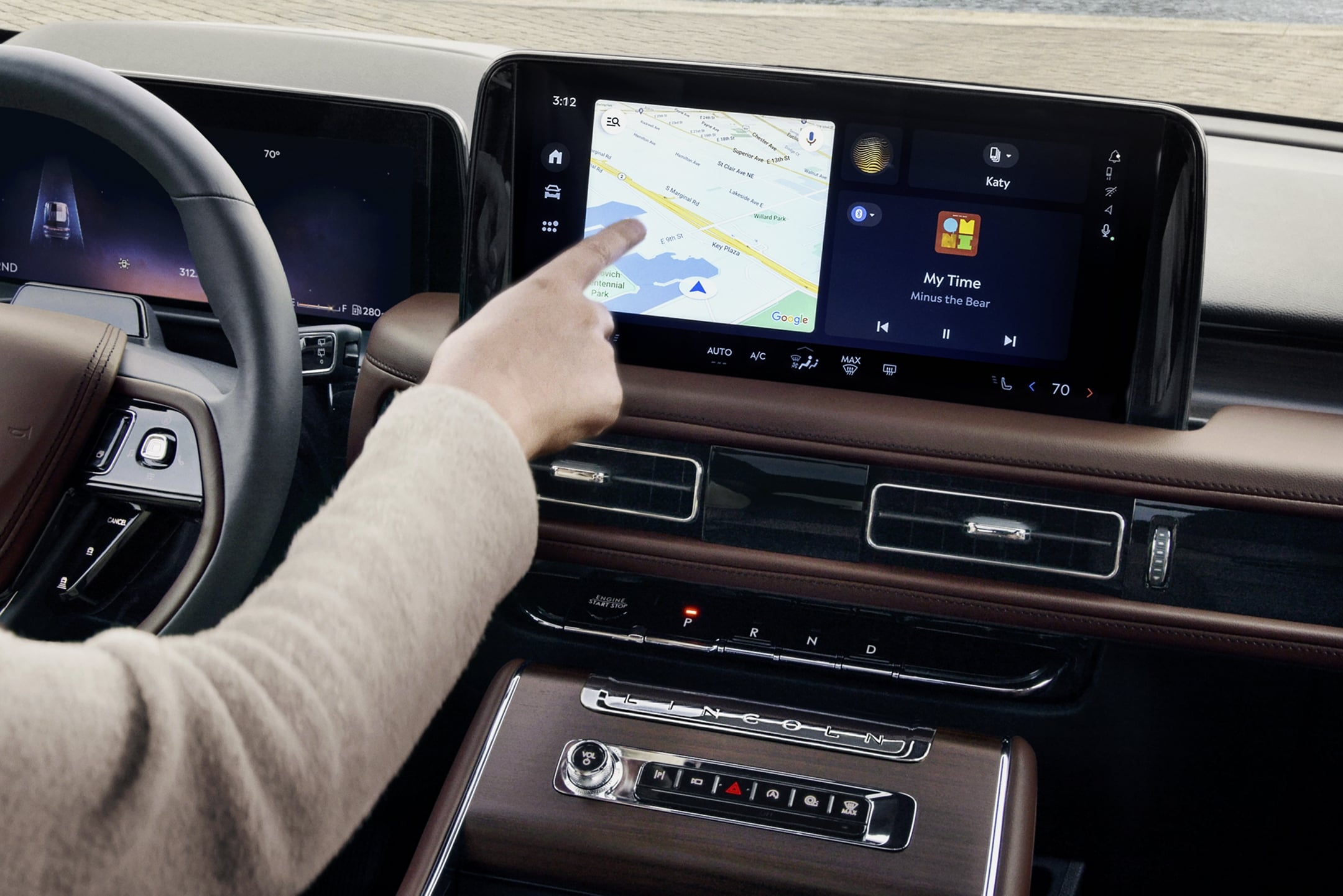 A person is tapping the center-stack touchscreen display of a 2025 Lincoln Aviator