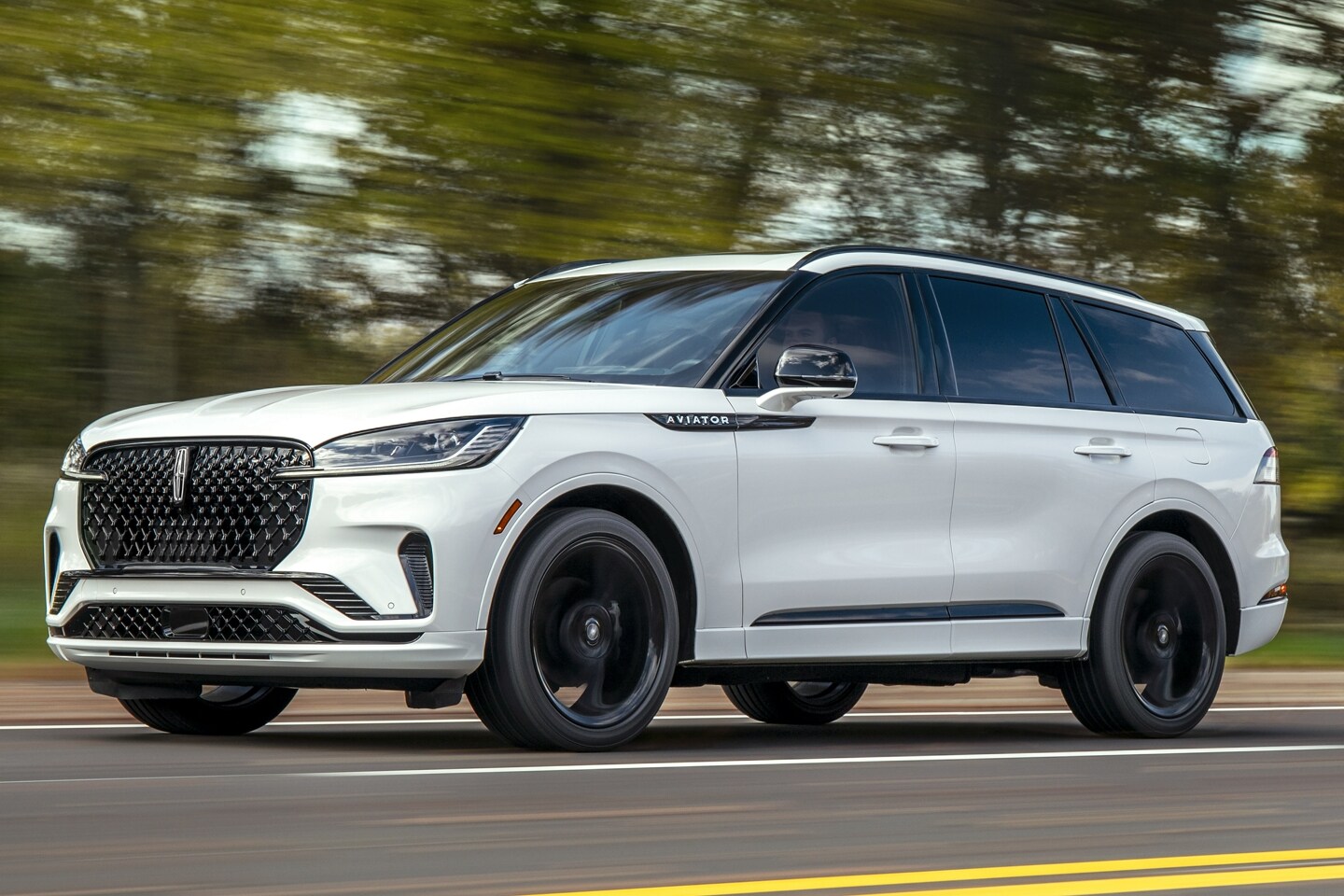A 2025 Lincoln Aviator Reserve is being driven on a scenic highway