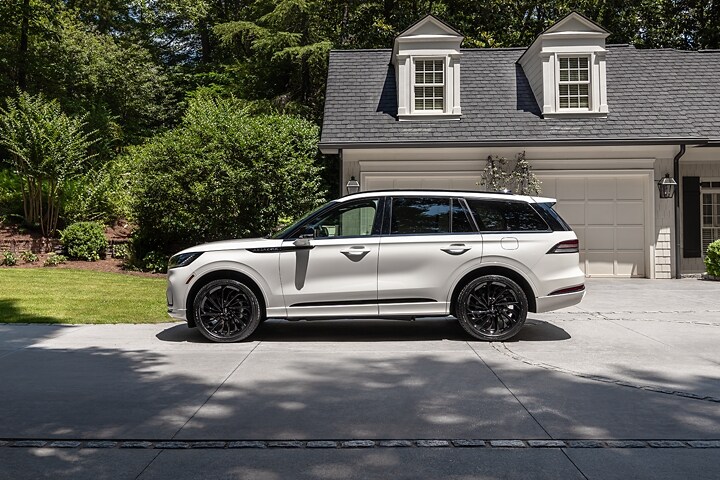 The 2025 Lincoln Aviator parked infront of a house.