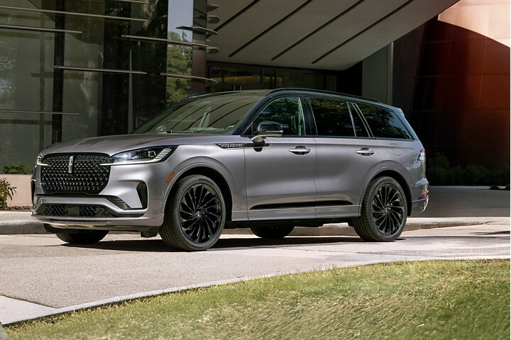 The 2025 Lincoln Aviator parked infront of a building.