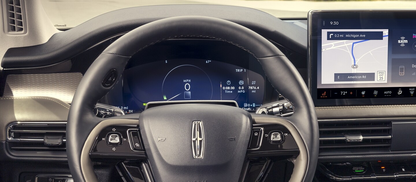 A considerate prompt alert is displayed in the digital cluster behind the steering wheel inside a 2023 Lincoln Corsair SUV.