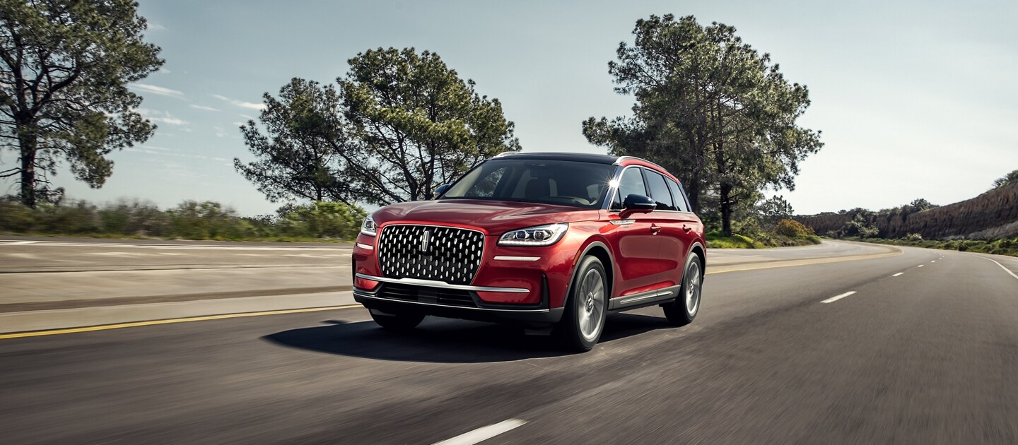 A 2023 Lincoln Corsair SUV is being driven on a coastal highway