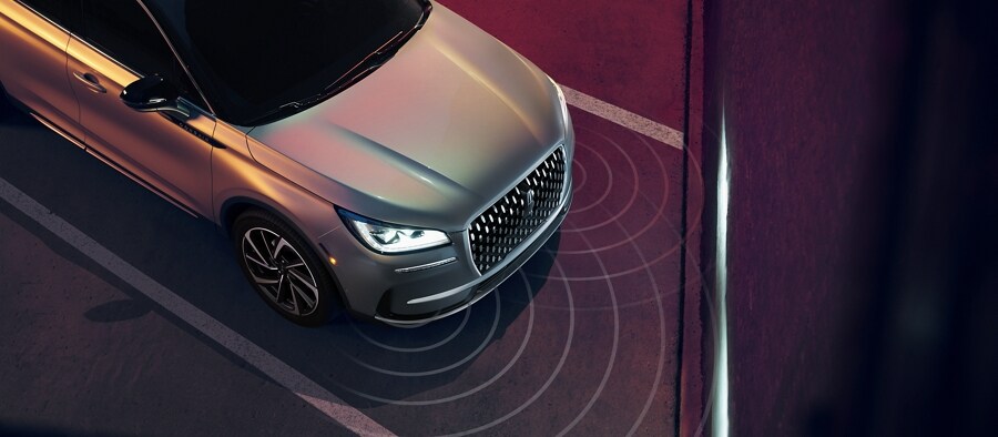 Simulated sensor beams are shown being emitted from the front of a 2023 Lincoln Corsair SUV