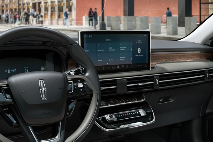 The centre screen inside a 2023 Lincoln Corsair SUV shows a home screen of SYNC® 4