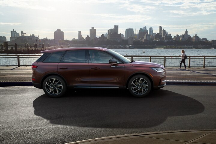 A 2023 Lincoln Corsair SUV is parked in a riverside park